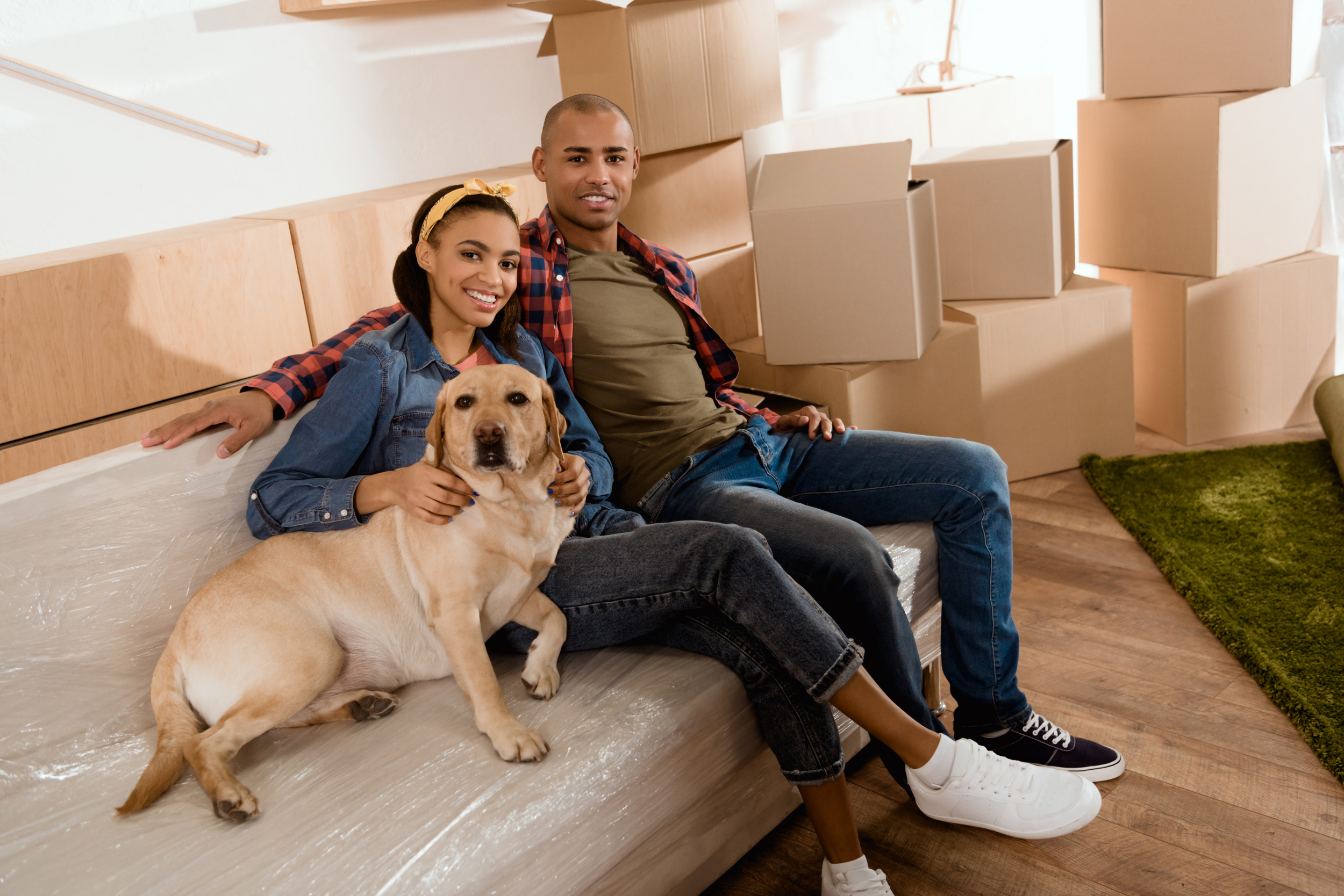 Young couple with dog moving into a new home