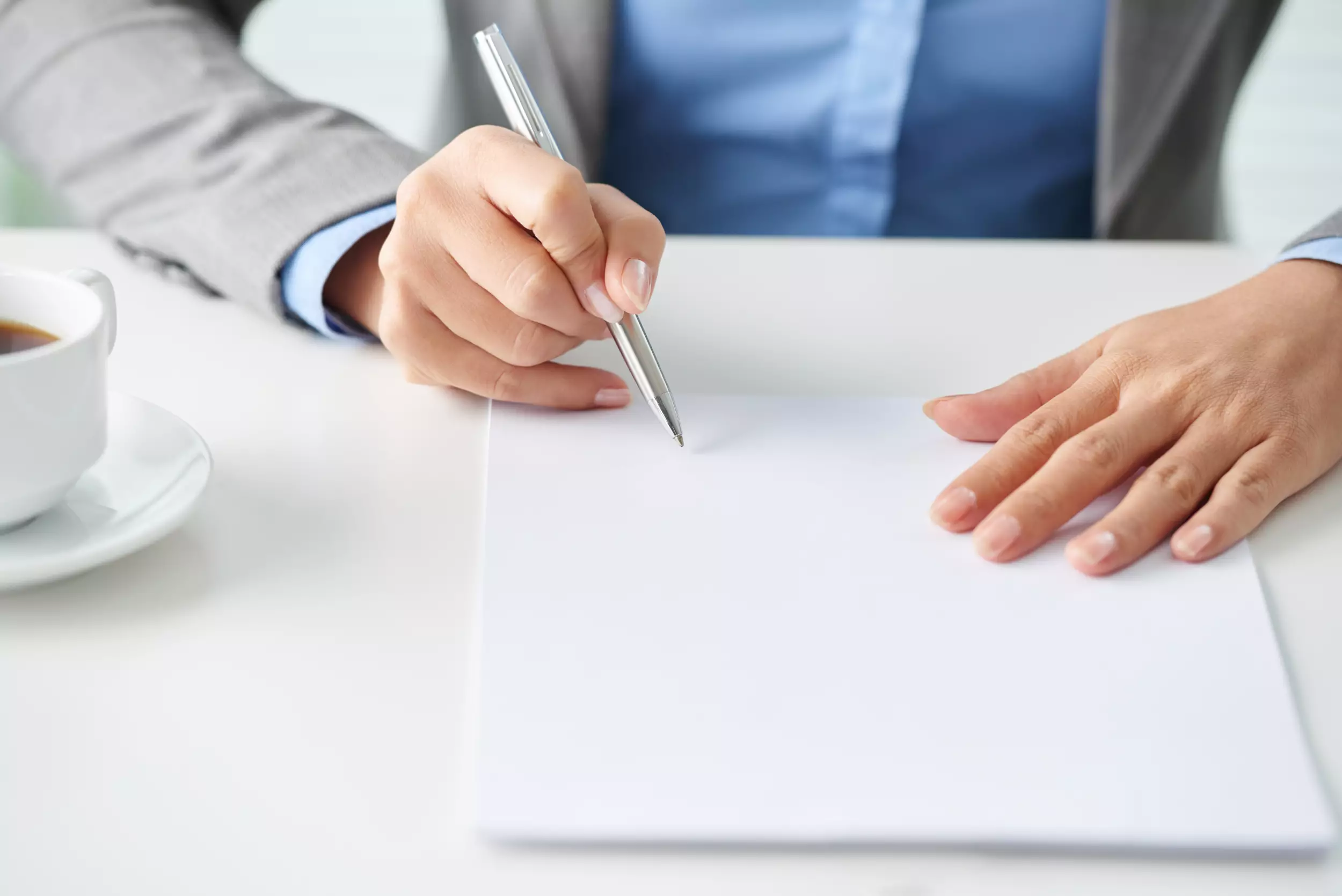 Woman signing mortgage document